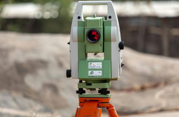 A surveying theodolite set on a tripod outdoors in Dassa, Benin, ideal for civil engineering projects.