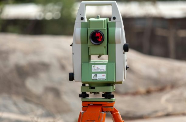 A surveying theodolite set on a tripod outdoors in Dassa, Benin, ideal for civil engineering projects.